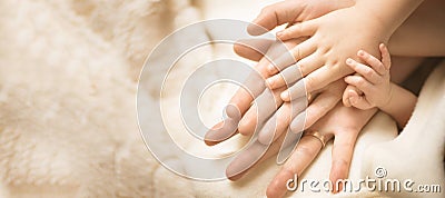 Newborn child hand. Closeup of baby hand into parents hands. Family, maternity and birth concept. Banner Stock Photo