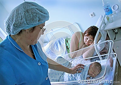 Newborn child and young mother in a maternity hospital Editorial Stock Photo