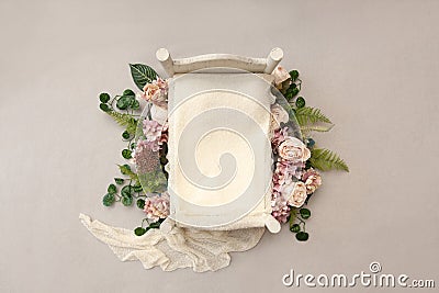 Newborn digital background - small wooden bed with white layer and floral decor Stock Photo