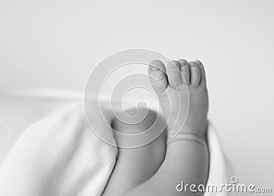 Newborn foot on beige background Stock Photo