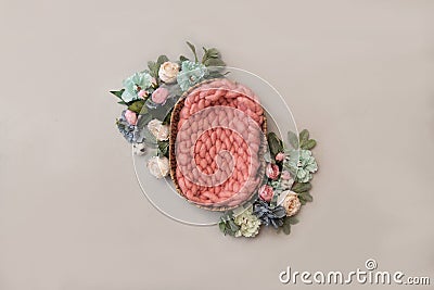 Newborn girl digital background - basket with pink chunky blanket and floral arrangements on light grey background Stock Photo