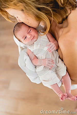 Newborn girl in loving arms of her mother Stock Photo