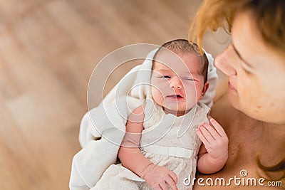 Newborn girl in loving arms of her mother Stock Photo