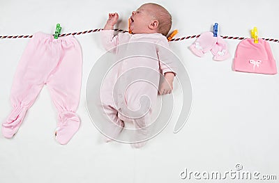 Newborn girl after washing laundry on a clothespin underwear, Stock Photo