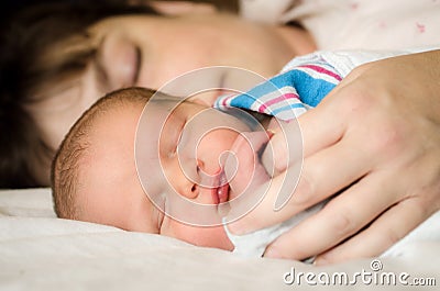 Newborn infant child resting next to mother after delivery Stock Photo