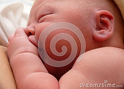 Newborn infant sucking his thumb Stock Photo