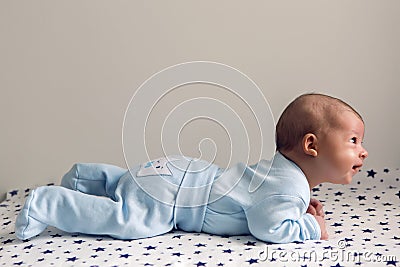 Newborn lies on the stomach on a diaper Stock Photo