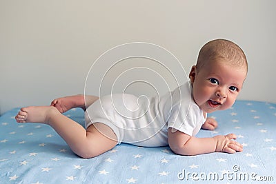 Newborn lies on the stomach on a diaper Stock Photo