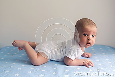 Newborn lies on the stomach on a diaper Stock Photo