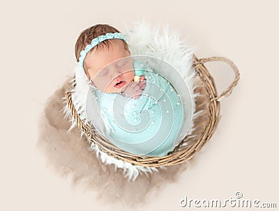 Newborn lying in basket Stock Photo