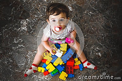 Newborn play building blocks - colorful toy bricks - above view Stock Photo