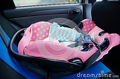 Newborn sleeping in car seat.Safety concept. Infant baby girl. secure driving with children. Baby care lifestyle. Cute baby Stock Photo