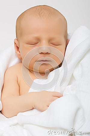 Newborn in white muslin Stock Photo