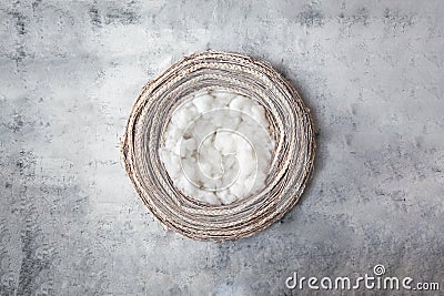 Newborn winter background - rustic snow covered wreath with fluff layer on brown background Stock Photo