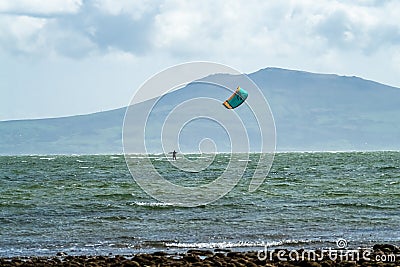 Newborough , Wales - April 26 2018 : Kite flyer surfing at Newborough beach - Wales - UK Editorial Stock Photo