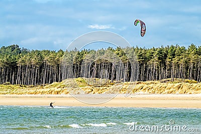 Newborough , Wales - April 26 2018 : Kite flyer surfing at Newborough beach - Wales - UK Editorial Stock Photo