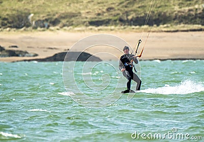 Newborough , Wales - April 26 2018: Martin Lamb is enjoying the beach with his kite Editorial Stock Photo