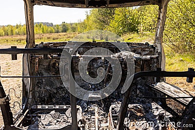 Newburn UK: A stolen car which has been burnt out and dumped in a field Editorial Stock Photo