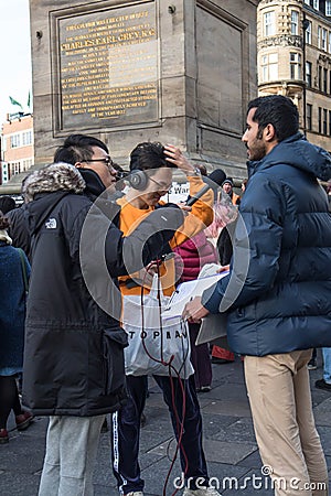 Man being interviewed with a microphone on the street Editorial Stock Photo