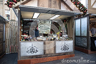 Market vendor stall selling galic and herbs in a winter street market Editorial Stock Photo