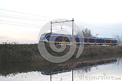 Newest dutch local sprinter SNG of CAF running between The Hague and Haarlem at Noordwijkerhout in the Netherlands. Editorial Stock Photo