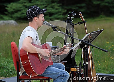 Newfoundlander with Red Guitar Editorial Stock Photo