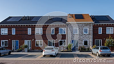 Newly build houses with solar panels attached on the roof against a sunny sky, housing market Editorial Stock Photo