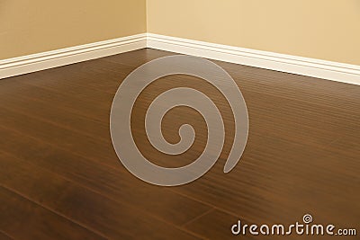 Newly Installed Brown Laminate Flooring and Baseboards in Home Stock Photo