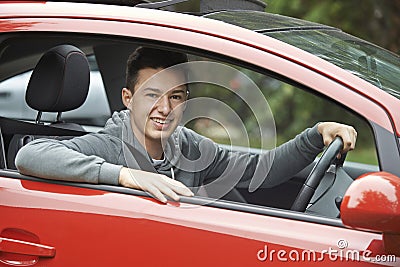 Newly Qualified Teenage Boy Driver Sitting In Car Stock Photo