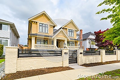 Newly renovated luxury residential house for sale. Big family house for with concrete pathway and metal fence Stock Photo