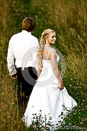 Newlywed couple in field Stock Photo