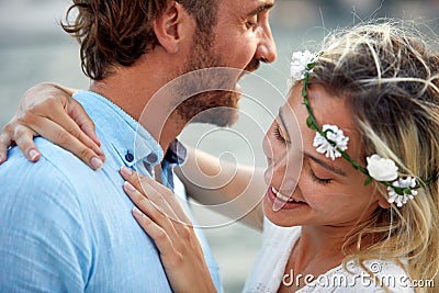 Newlywed couple in hug by seaside. Portrait shot. Joyful and carefree couple. Wedding, travel, love concept Stock Photo