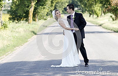 Newlywed couple on road Stock Photo