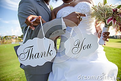 Newlywed couple with thank you sign Stock Photo