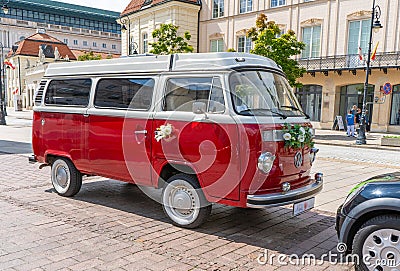Newlyweds car. Red minibus volkswagen. Retro bus car. Decorated with bouquets of flowers. Festive decor, bridal bouquet Editorial Stock Photo