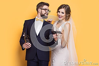 Newlyweds celebrating drinking red wine Stock Photo