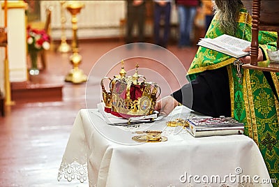 Newlyweds exchange wedding rings on a ceremony in the church Stock Photo