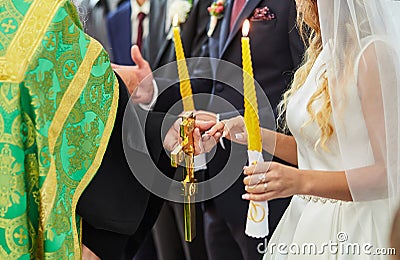 Newlyweds exchange wedding rings on a ceremony in the church Stock Photo