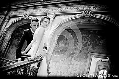 Newlyweds kissing near old stairs Stock Photo