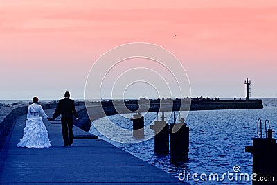 Newlyweds sea sunset walk Stock Photo