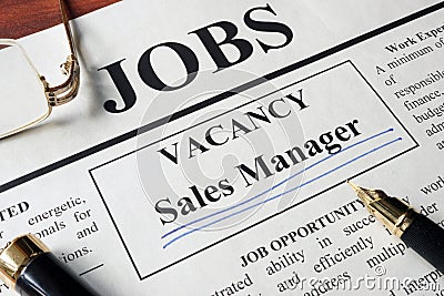 Newspaper with ads for vacancy sales manager. Stock Photo