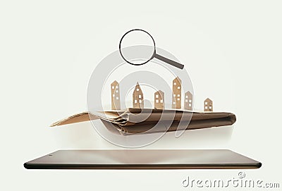 The newspaper with paper houses is hovers over tablet pc. Stock Photo