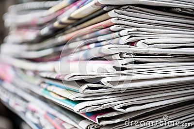 Newspapers folded and stacked on the table background. Colorful newspaper. Image shallow depth of field Stock Photo