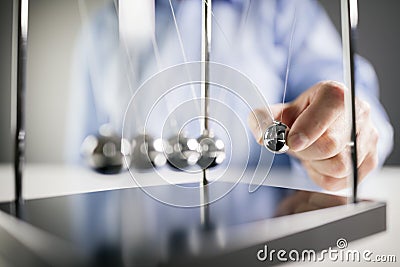 Newton`s cradle businessman concept for cause and effect Stock Photo