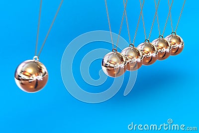 Newtons Cradle on a Blue Background Stock Photo