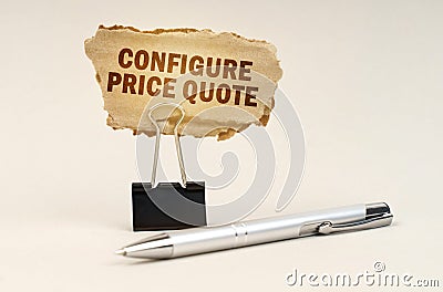 Next to the handle is an office clip with a sign. On the plate is the inscription - Configure Price Quote Stock Photo