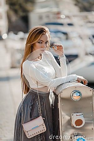 Fashion lifestyle portrait of young happy pretty woman laughing and having fun on the street at nice sunny summer day Stock Photo