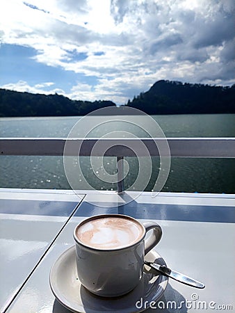 A cup of chocolate with beautiful lake view Stock Photo
