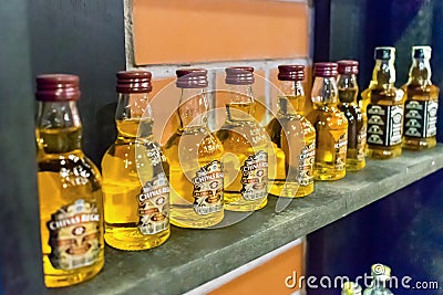 NHA TRANG, VIETNAM - APRIL 17, 2019: A row of small bottles of alcohol on the shelf in store Editorial Stock Photo