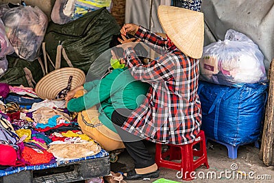 Catching lice on market, Nha Trang, Vietnam Editorial Stock Photo